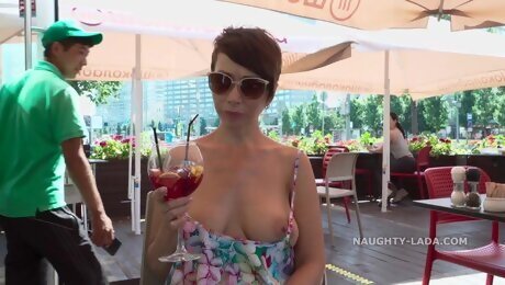 Short-haired MILF shows her boobs in public